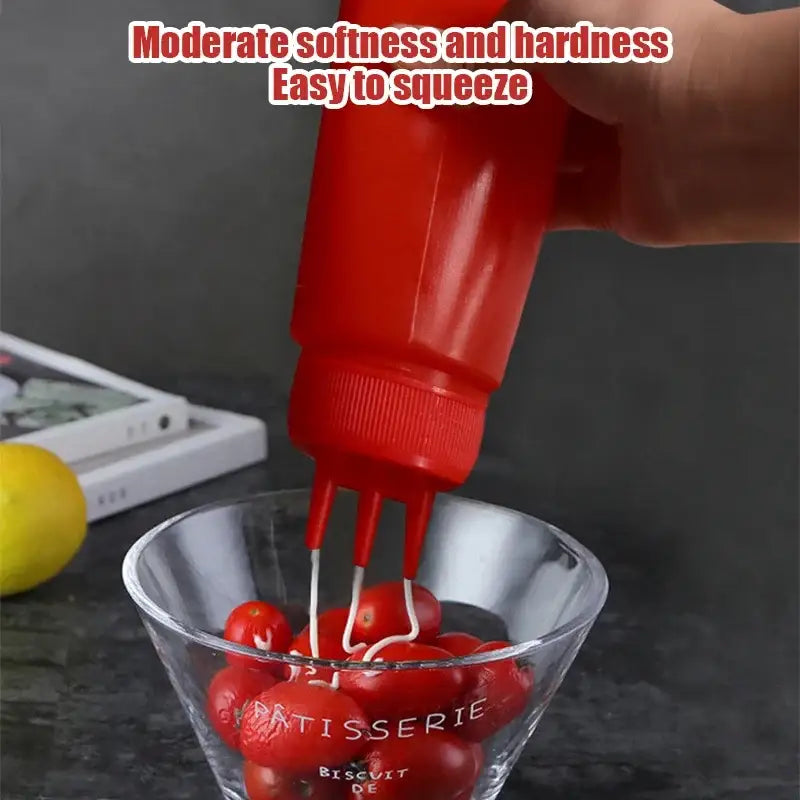 Red plastic squeeze bottle condiment dispenser with three prongs for multi-color kitchen use on the back side