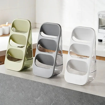 Three modern 3-tier cutlery racks in sage green gray and white with transparent bases for kitchen utensil organization