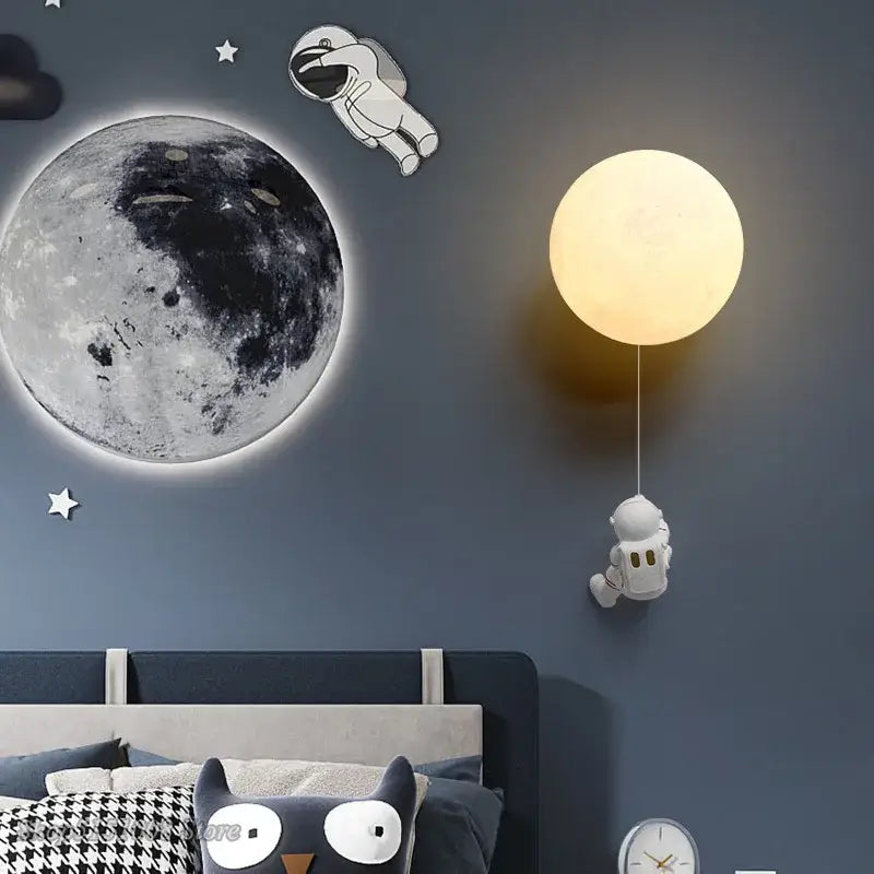 Warm glowing spherical wall lamp with dangling astronaut figurine for kids bedroom decorbites astronaut moon wall