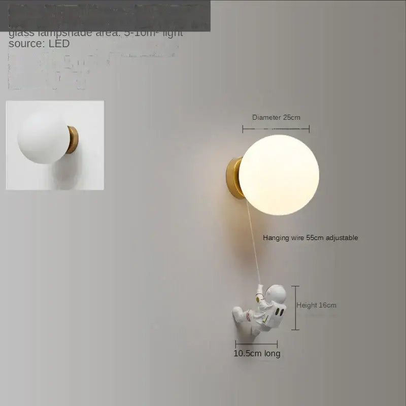 White spherical glass lampshade wall lamp with gold fixture and decorbites astronaut moon figurine for kids bedroom