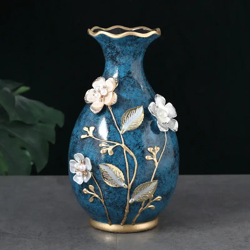 Glossy teal ceramic vase with gold-trimmed fluted rim and base, white floral appliqués for dried flowers display