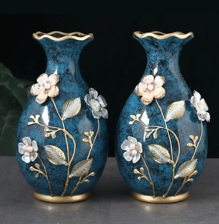 Pair of deep teal 3D ceramic vases with gold-trimmed rims and floral appliqués for dried flowers and wobble plate decor