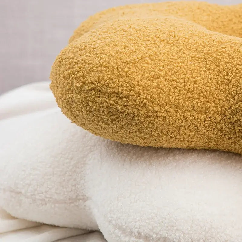 A plush mustard yellow teddy bear shaped pillow with soft fleece surface from decorbites 3d flower nordic cushion set