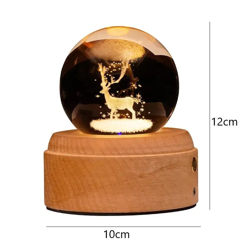 A warm glowing 3d galaxy crystal ball night light with golden reindeer and wooden music box base decorbites crystal ball
