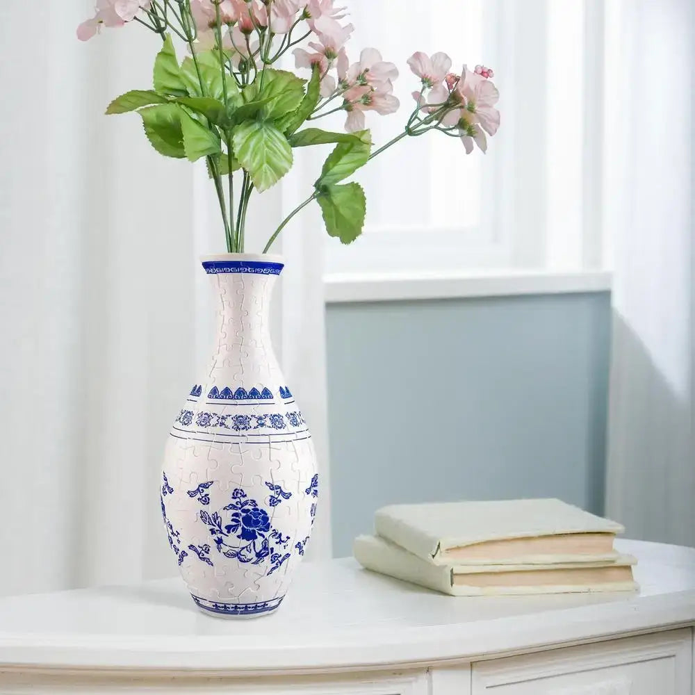 White ceramic puzzle vase with blue floral and geometric patterns featuring a slender neck in a 3d puzzle building set