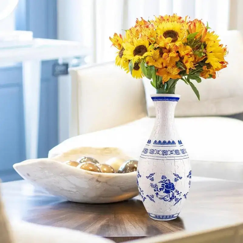 A white ceramic 3d puzzle vase with blue floral and geometric patterns featuring a crackled glaze finish building set