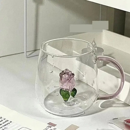 Clear glass rose champagne flute with delicate pink 3d rose and green leaves embedded in the base by decorbites