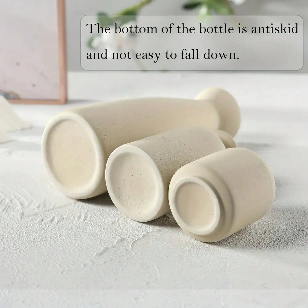 Three off-white ceramic vases with textured matte finishes and rounded bases for modern bohemian home decoration