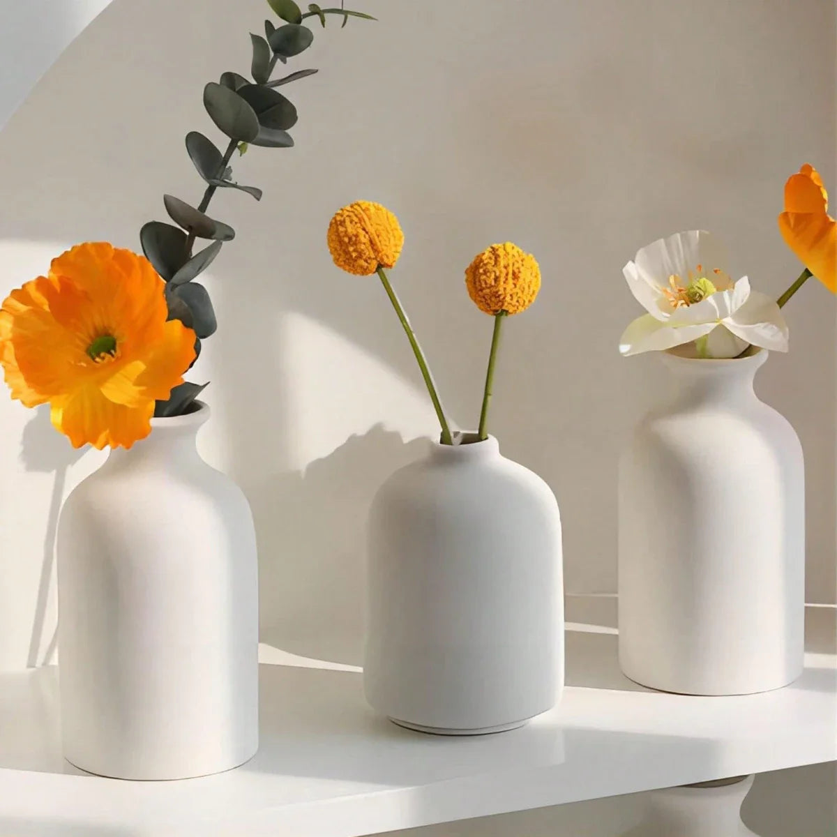 Three minimalist white ceramic vases with different flowers in a 3pcs bohemian modern farmhouse vase set for home decor