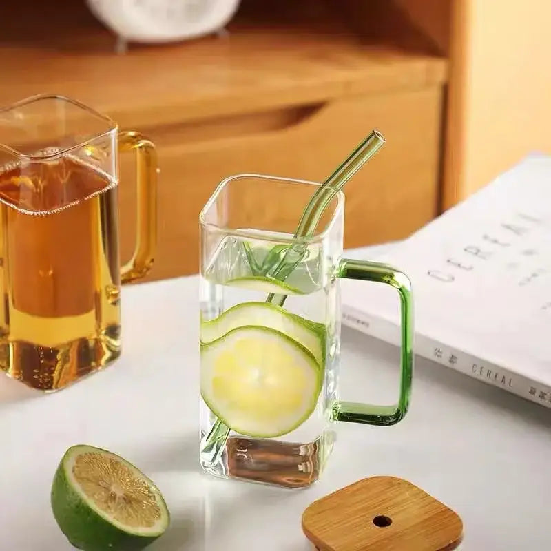 400ml square glass mug with green handle and straw filled with water and lime slices for dining room use