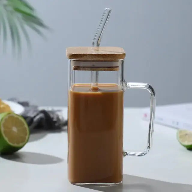 Clear glass mug with bamboo lid and handle filled with brown iced coffee 400ml square glass mug for dining room use