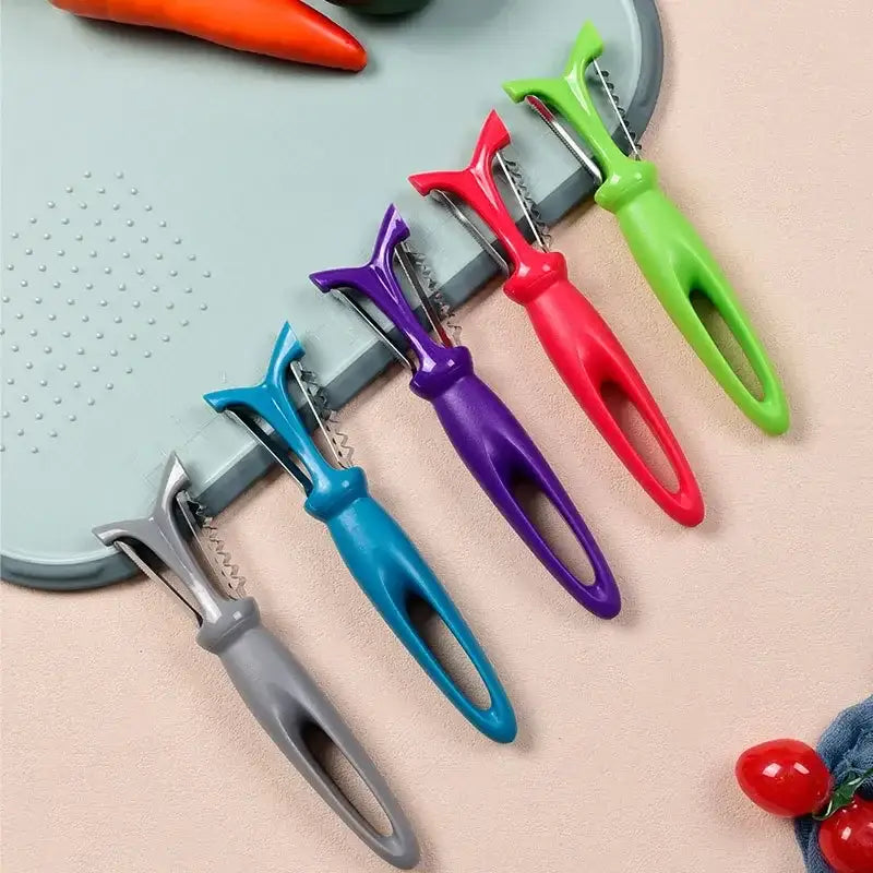 Set of five colorful stainless steel vegetable peelers with ergonomic plastic handles in gray blue purple red and green