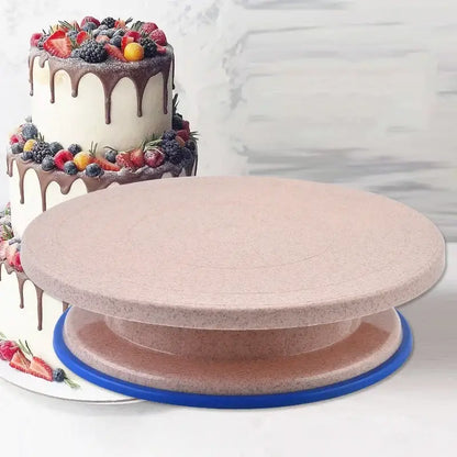 Pink two-tiered cake stand with blue base and speckled surface for decorbites cake decorating turntable set