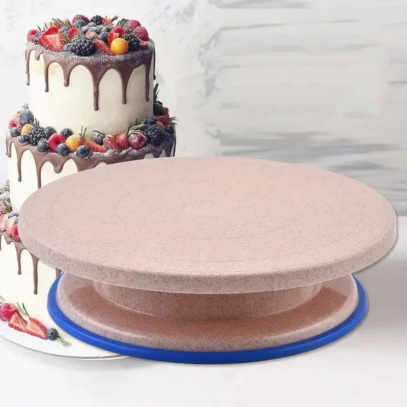 Pink two-tiered cake stand with blue base and speckled surface for decorbites cake decorating turntable set