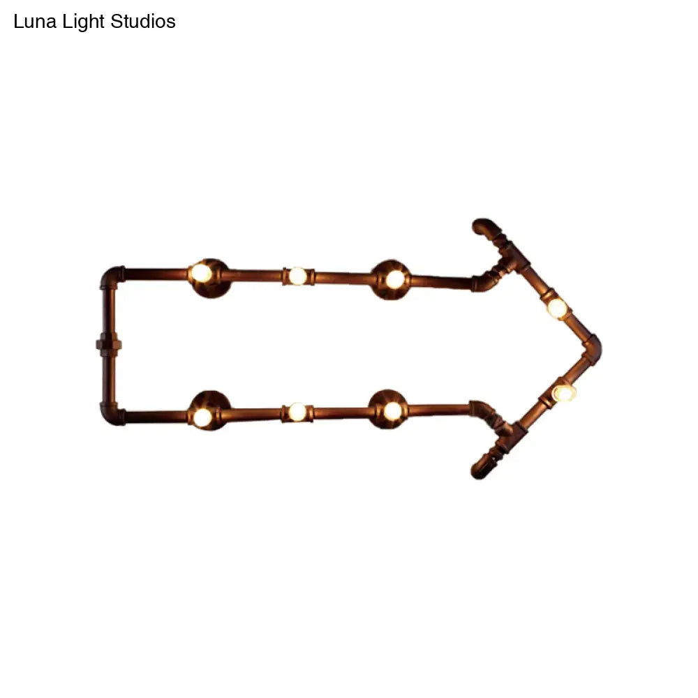 Aplique de pared industrial de bronce con diseño de flecha y detalle de tubería de agua, con 8 luces.