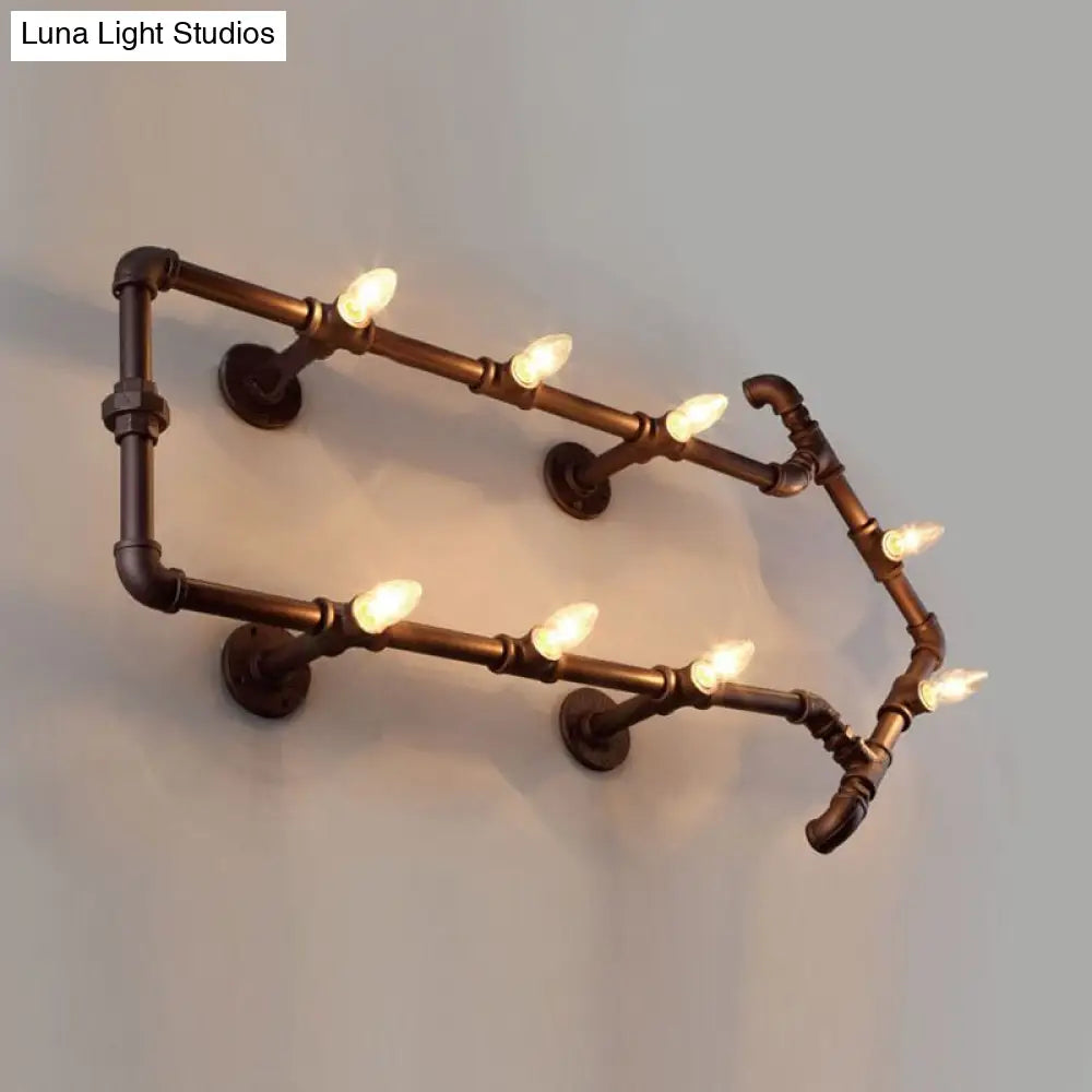 Aplique de pared industrial de bronce con diseño de flecha y detalle de tubería de agua, con 8 luces.