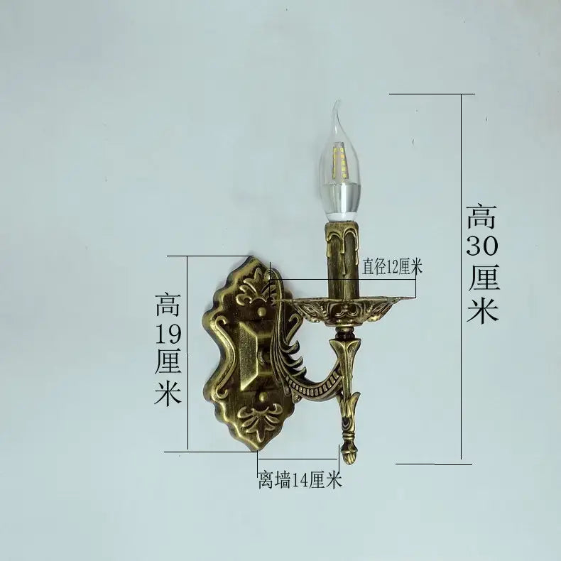 Antique gold retro european wall light bedroom ornate sconce featuring an antique brass wall sconce with ornate floral and scrollwork design and a single candle-style bulb.
