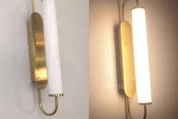 Modern minimalist gold led wall lamp featuring a sleek cylindrical frosted glass shade and a curved metal arm suitable for bedroom use.
