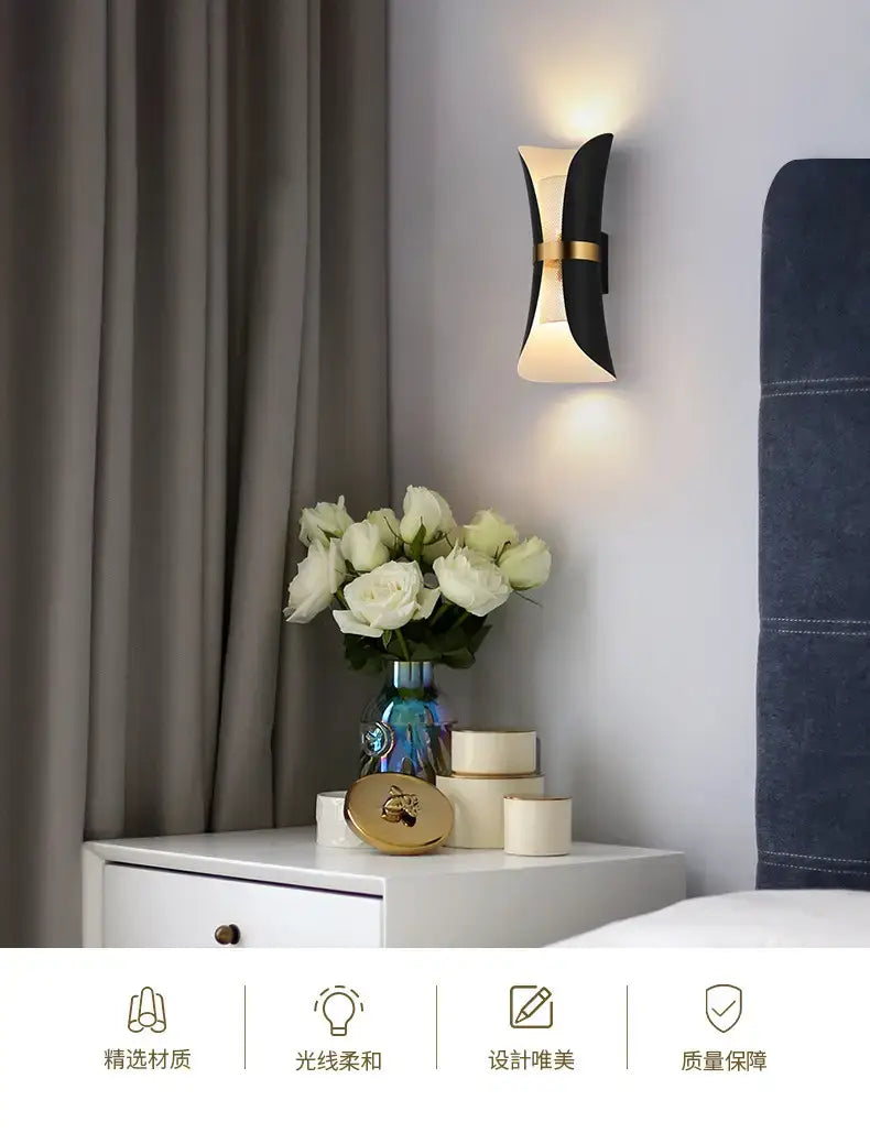 Modern black and gold curved wall lamp with a sleek design ideal for bedroom lighting.