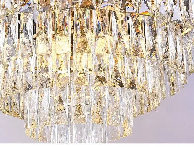 A luxury k9 crystal tiered chandelier in black and gold features cascading faceted crystal prisms with gold-toned metallic accents designed for dining room lighting, ideal for nebra luxury crystal chandeliers.