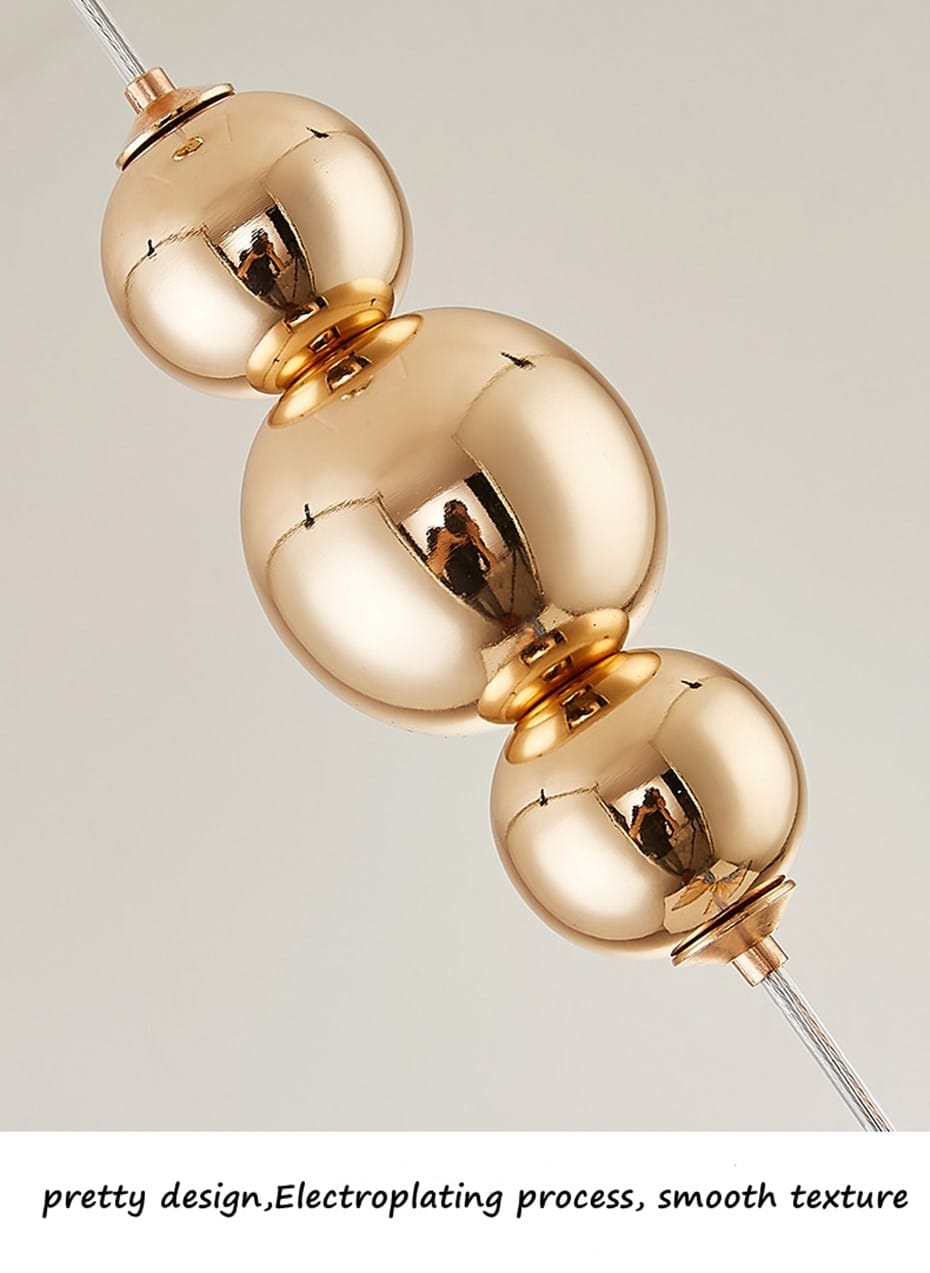 gold-colored spherical pendant wall light with smooth reflective surface and polished metallic finish designed for bedroom use in a nordic butterfly led butterfly led wall collection