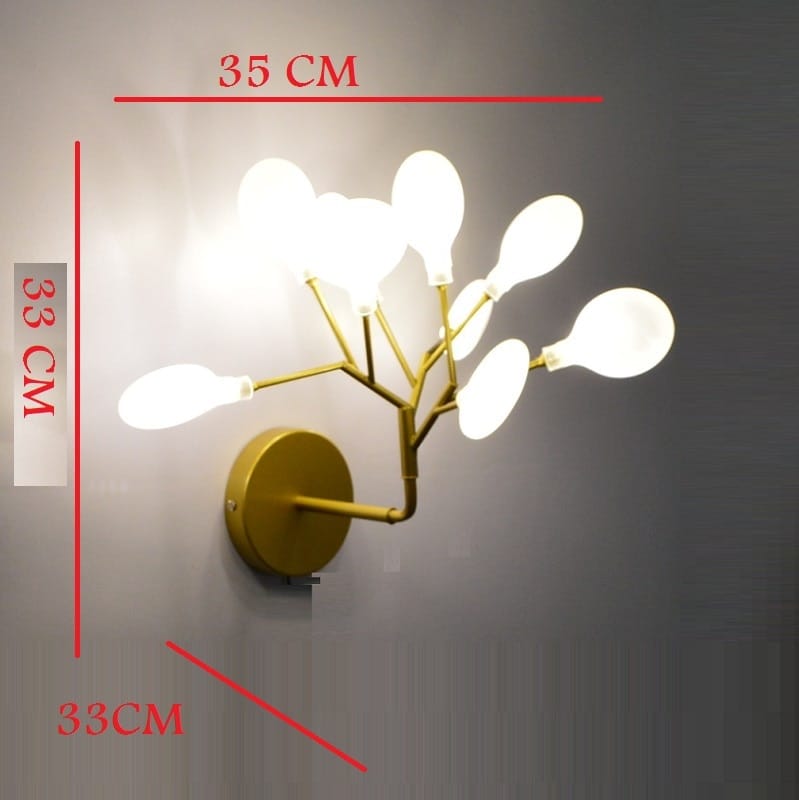 Modern gold firefly tree branch led wall light features a gold-toned wall sconce with six frosted glass bulb shades in a branching tree-like design ideal for bedroom use.
