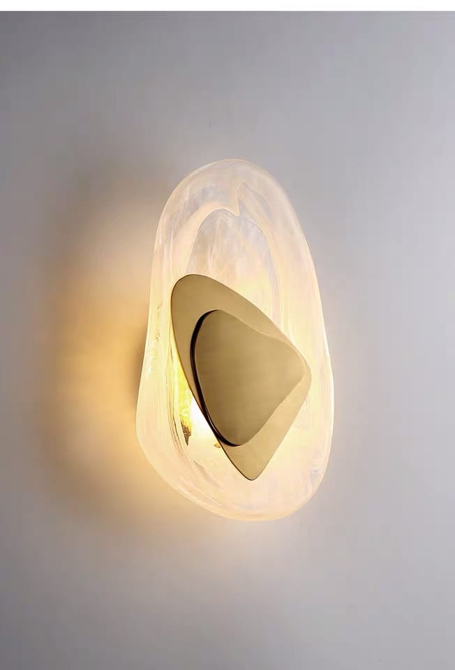 Modern creative minimalist glass wall lamp featuring a translucent frosted glass outer shell and polished brass inner element designed for bedroom bedside lighting.