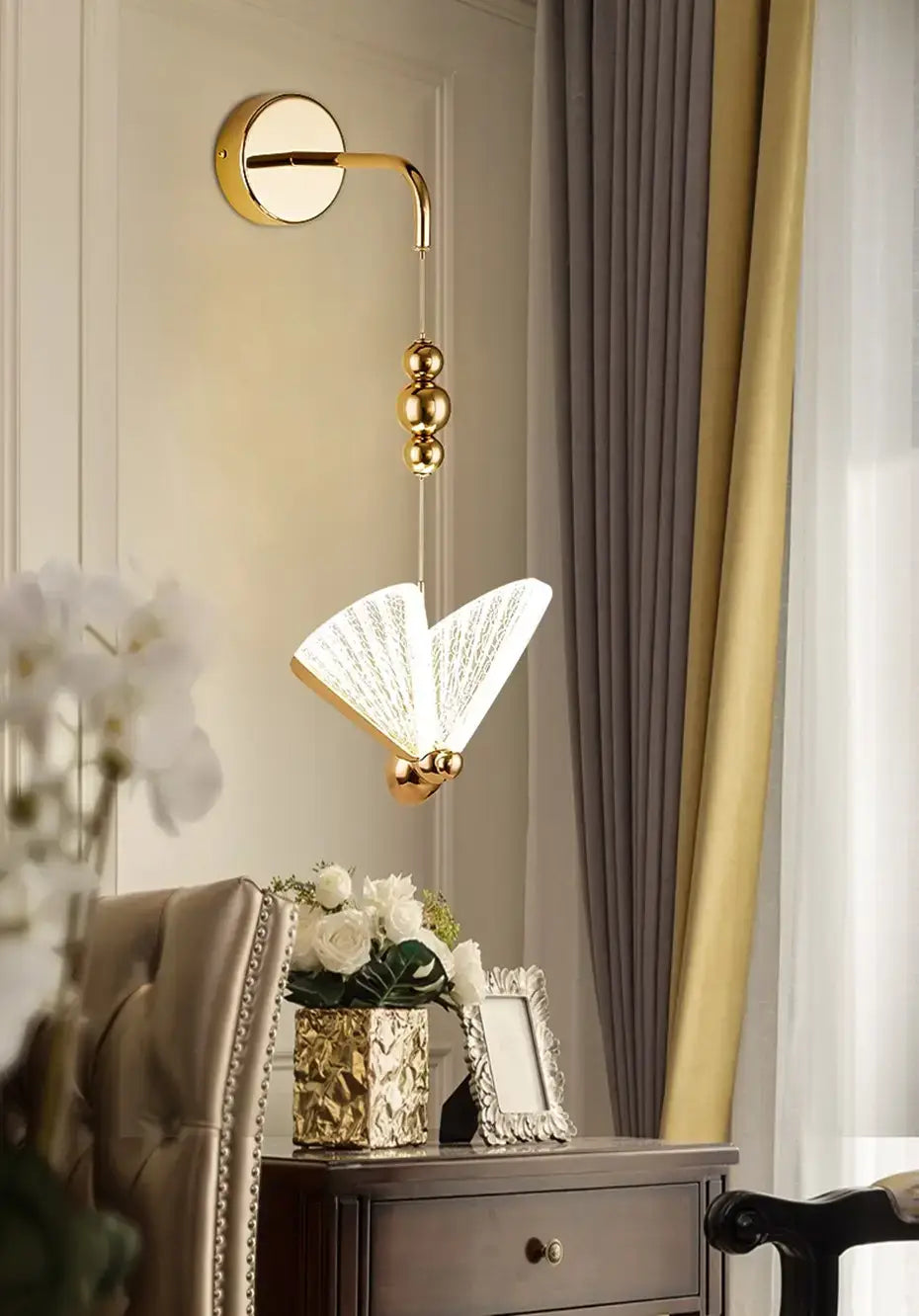 gold-toned wall light with a patterned butterfly nordic led book-shaped lampshade emitting soft warm light for bedroom use.