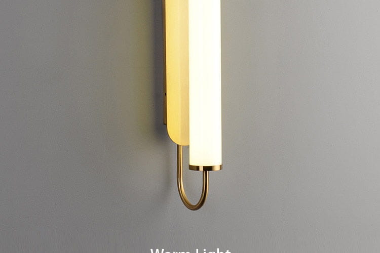 Modern minimalist gold led wall lamp featuring a sleek cylindrical frosted glass shade with polished brass accents as a stylish bedroom led wall sconce.
