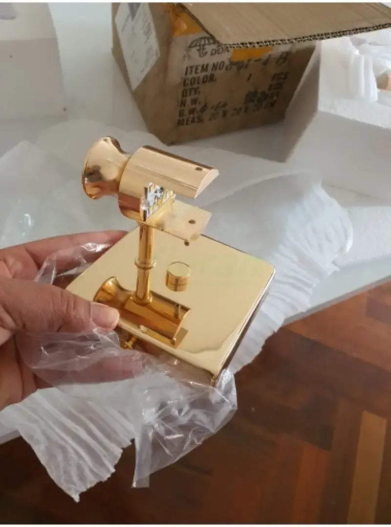 gold-finished brass door knob and plate assembly with sleek modern design featured alongside a modern gold crystal led wall lamp for bathroom three globe light emphasizing simple crystal led and led wall lamp elements.