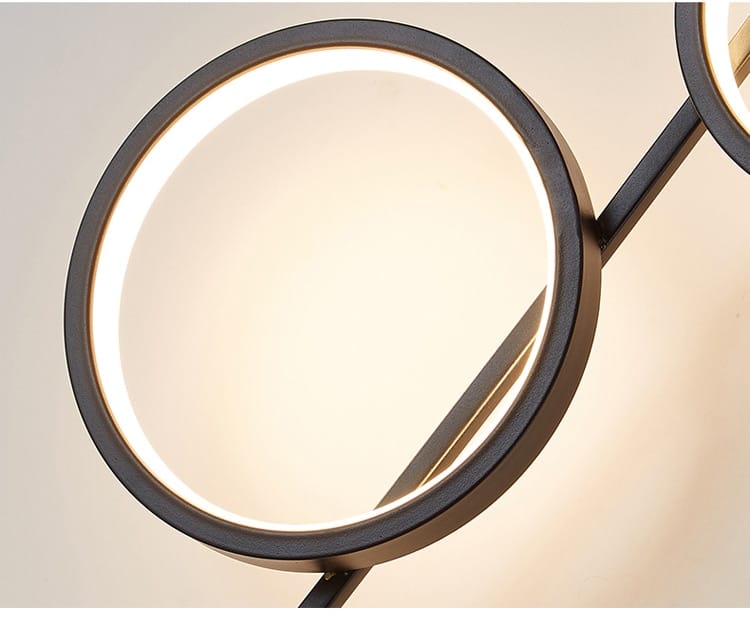 modern black circular mirror with a glowing led light ring designed to complement nordic linear long led wall and long led wall lights in living room sconces.