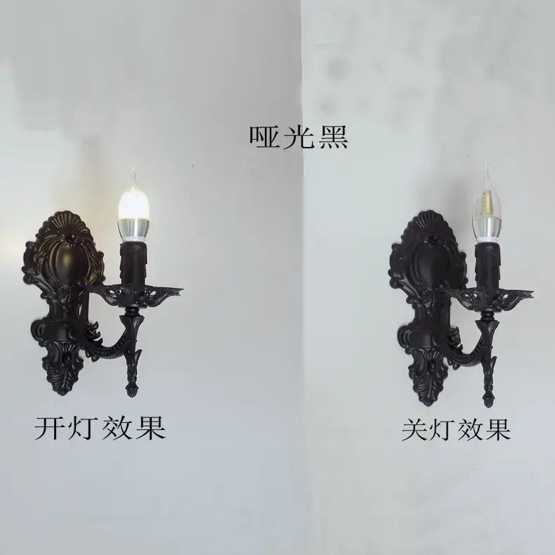 Matte black ornate wall sconce with intricate scrollwork and a single candle-style bulb designed as a creative retro european wall light for bedroom use.