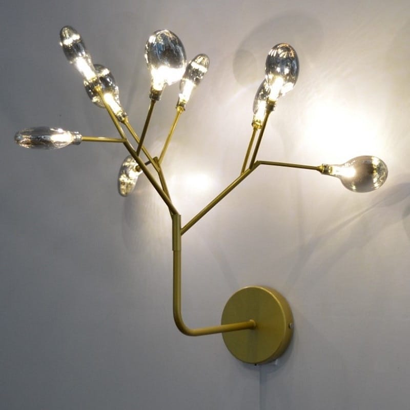 modern gold firefly tree branch led wall light featuring a gold-toned wall sconce with multiple branching arms each holding a clear teardrop-shaped glass bulb for bedroom use.