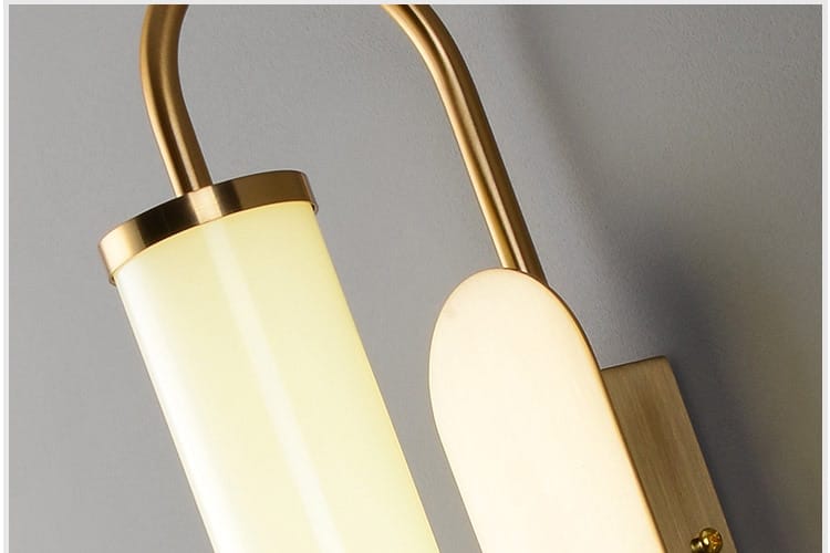 Modern minimalist gold led wall lamp featuring a cylindrical frosted glass shade and an elongated oval diffuser ideal for bedroom use.