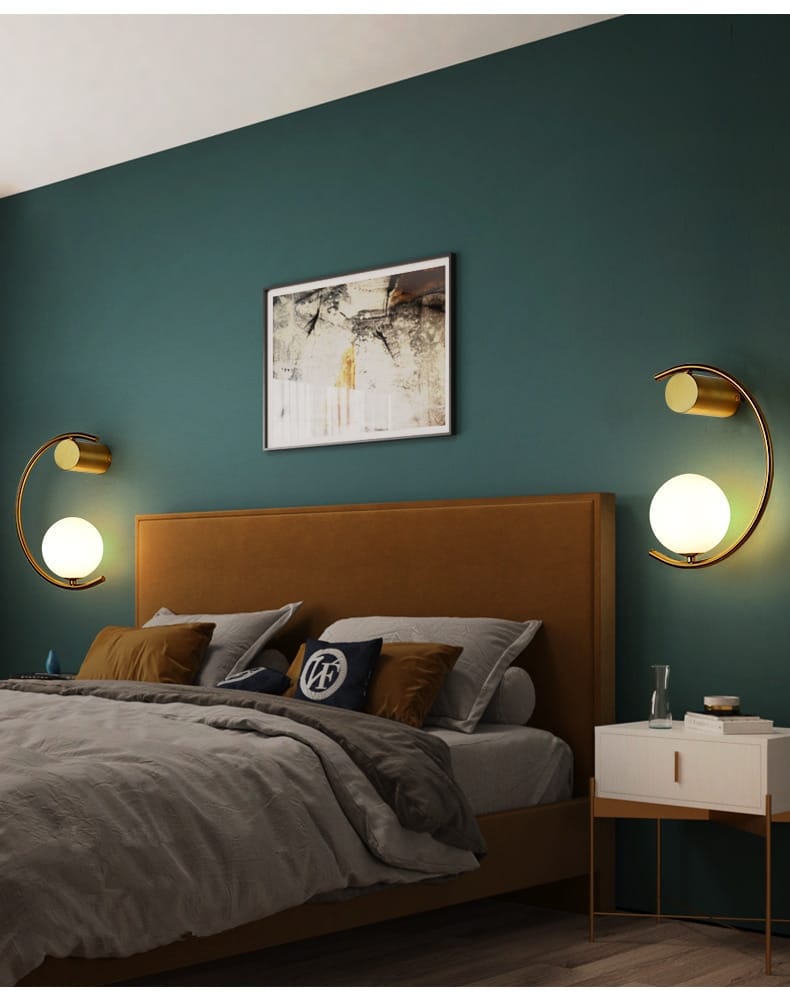 Modern gold luxury creative led crescent-shaped bedside wall sconces with frosted glass globe shades for bedroom use.