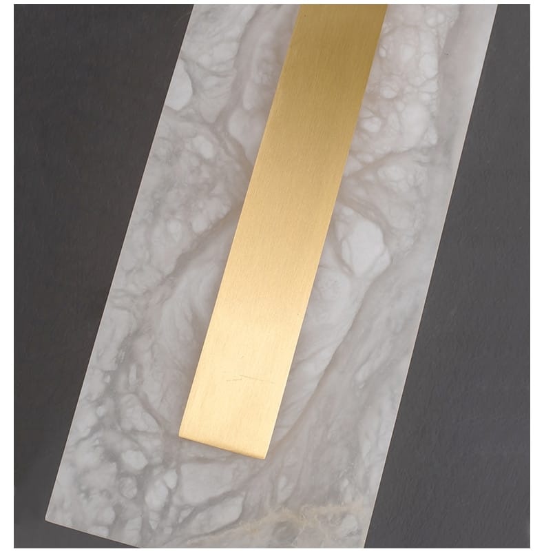 A sleek rectangular gold-colored metal bar with a smooth polished finish featured as part of a postmodern gold copper marble wall lamp for living room.