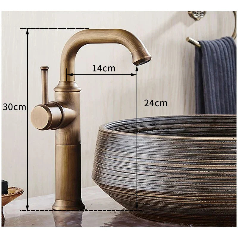 DecorBites™ single handle antique brass bathroom faucet with a curved spout and cylindrical base in a brass bathroom faucet finish.
