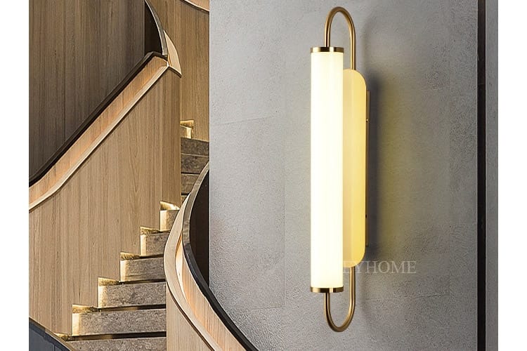 modern minimalist gold led wall lamp featuring a brass-finished wall sconce with a sleek cylindrical frosted glass diffuser emitting warm ambient light.