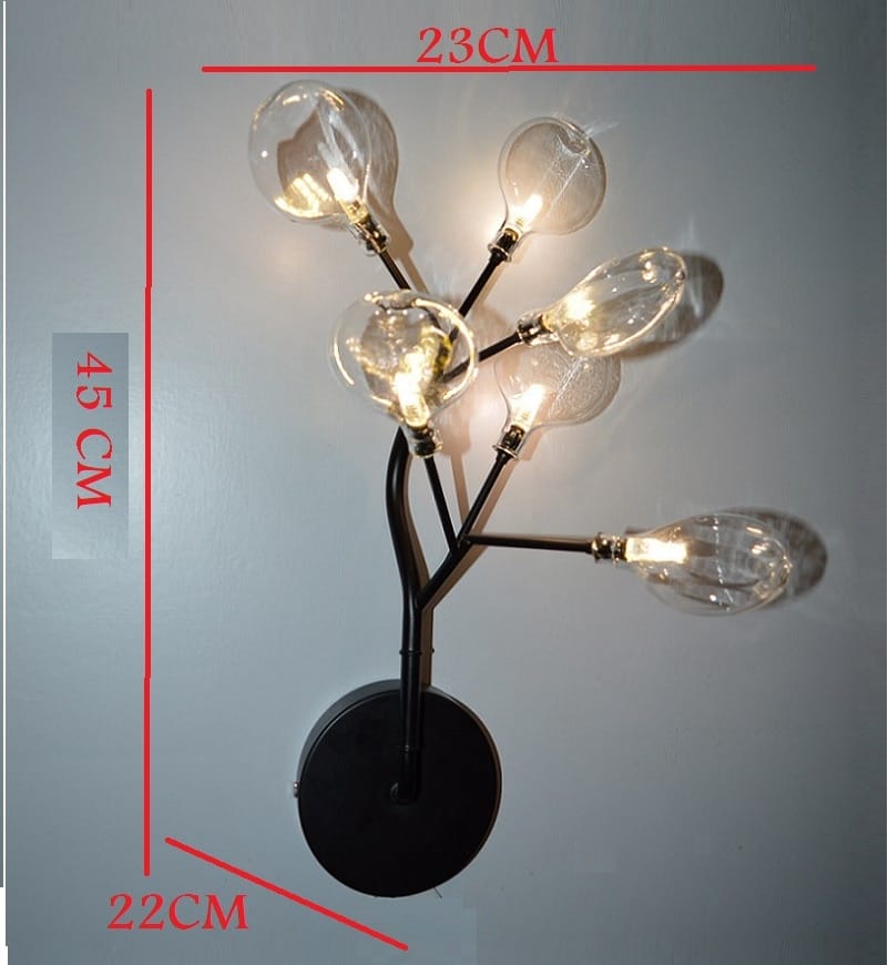black metal led wall light with six clear glass bulb arms in a branching tree design for modern bedroom lighting