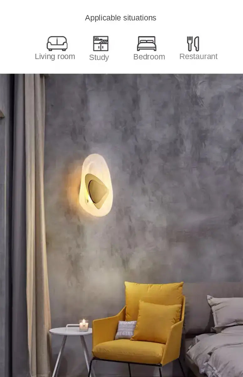 Modern creative minimalist glass wall lamp with an organic shell-like design and warm glowing light for bedroom bedside lighting.