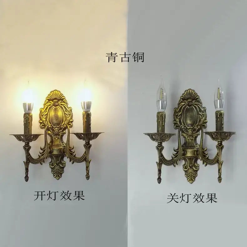 Antique brass two-light wall sconce with an ornate shell-shaped central medallion and candle-style arms designed as a creative retro european wall light for bedroom decor.