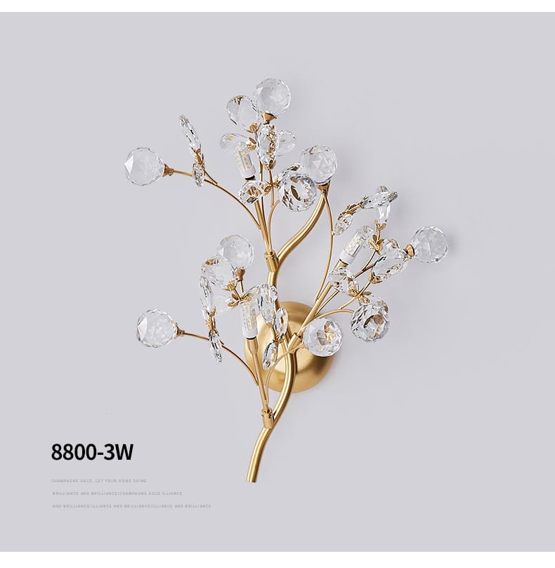 post modern luxury gold-toned crystal branch wall sconce featuring clear faceted crystals for a bedroom light in luxury branch style