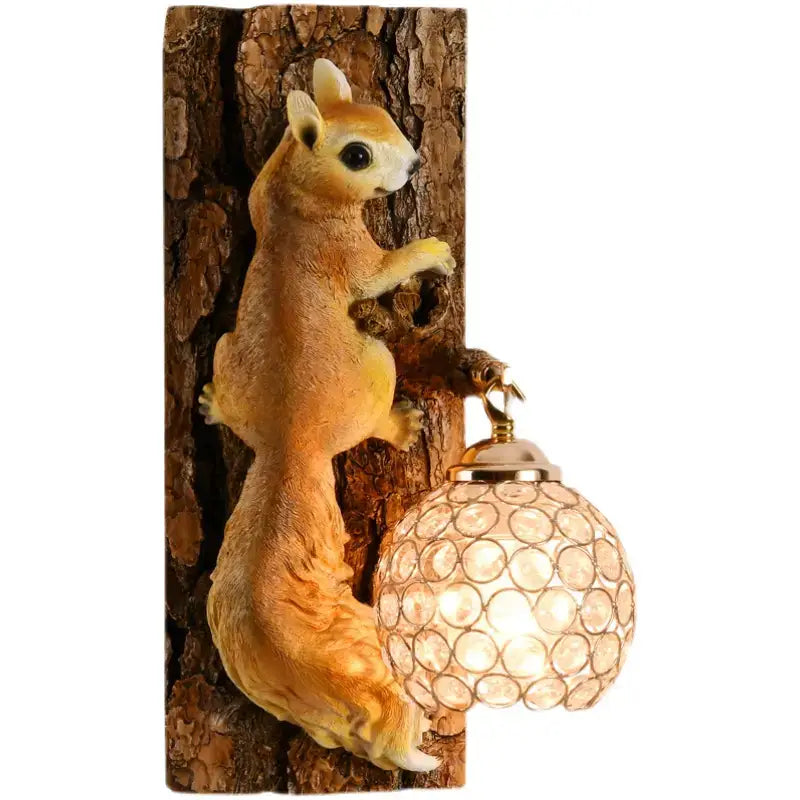 A charming golden-brown vintage style resin squirrel wall lamp with detailed fur clings to a textured tree trunk holding a spherical lampshade with circular glass pieces in nordic vintage style for bedroom light.