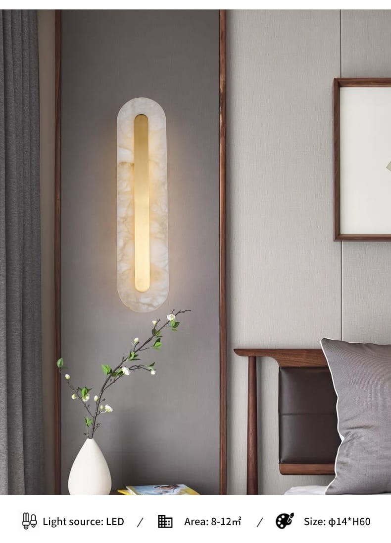 Modern minimalist wall lamp with a sleek elongated oval design featuring a warm led light source encased in a smooth white marble-like copper marble wall lamp ideal for living room use.