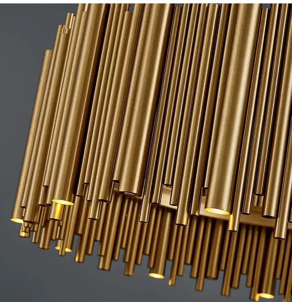 Luxury modern round gold chandelier featuring a golden brass cylindrical design with varying lengths and diameters for a living room modern round gold industrial pendant light.