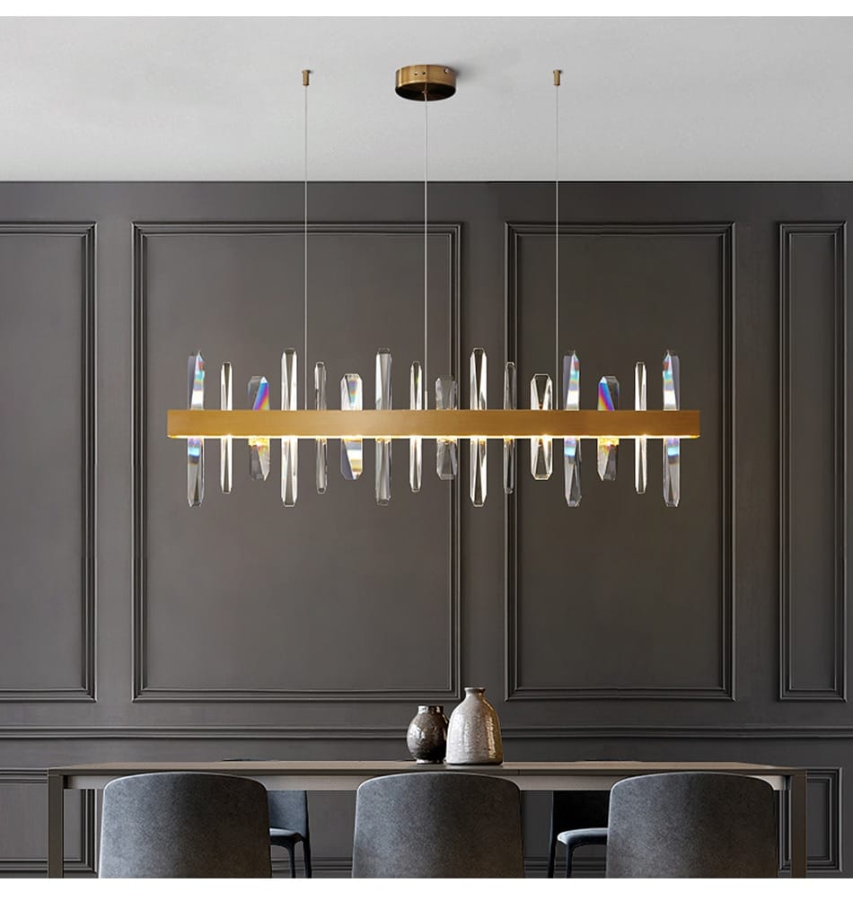 Modern rectangle gold crystal chandelier featuring clear crystal prisms hanging from a central bar, ideal for dining room lighting.