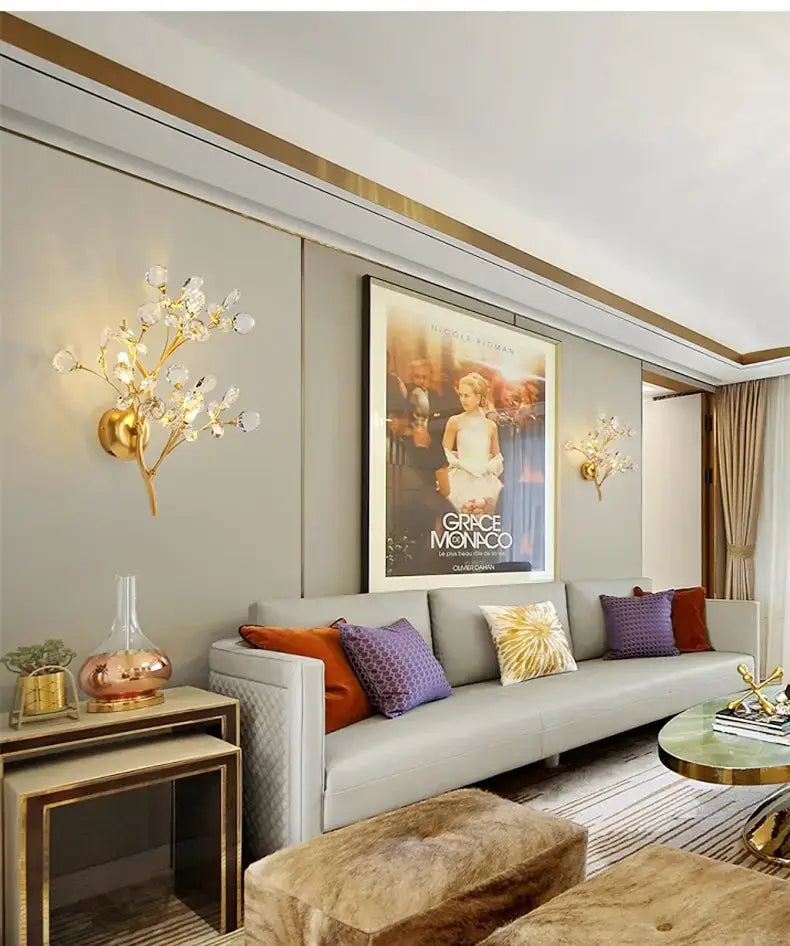 post modern luxury gold-toned wall sconce featuring crystal-like blossoms in a modern luxury branch design for bedroom lighting