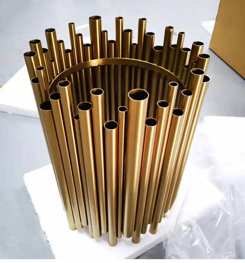 Luxury modern round gold chandelier featuring a golden metallic cylindrical tube sculpture with varying lengths radiating outward from a central circular base ideal for living room use.