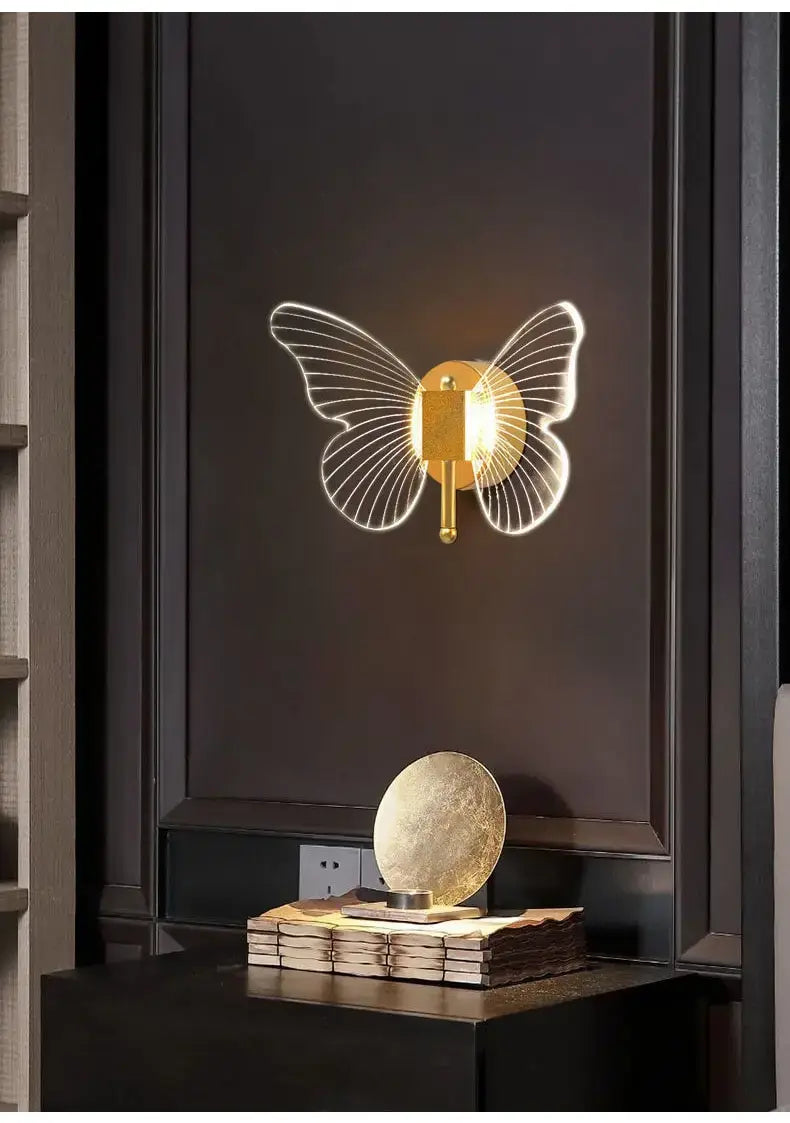modern nordic gold led butterfly wall lamp featuring a gold-toned copper led butterfly design with illuminated translucent wings for bedroom use.