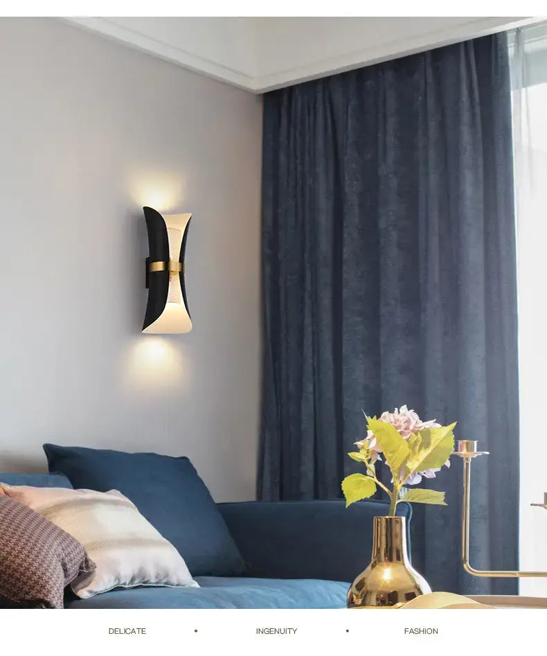 Modern black and gold curved wall lamp with a sleek design suitable for bedroom lighting.